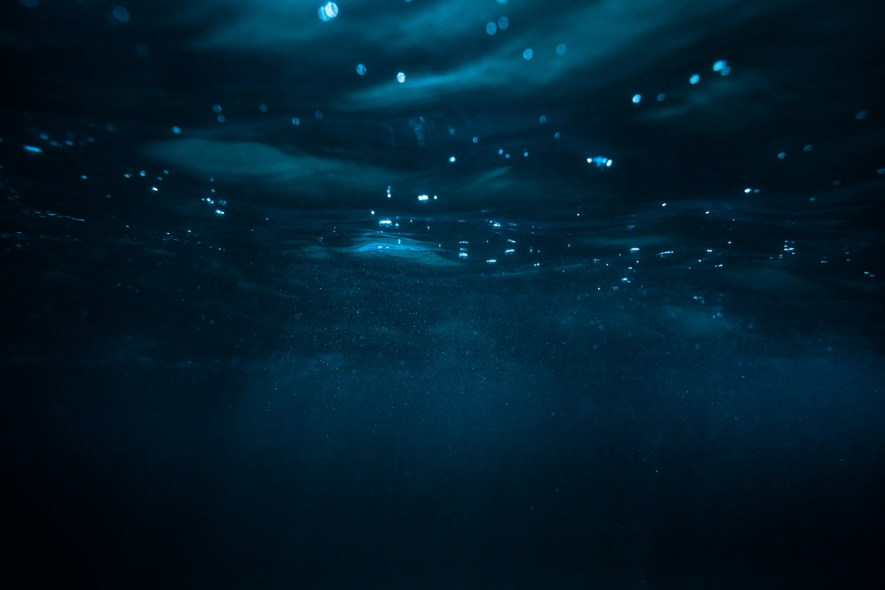 Light filtering through dark blue ocean water